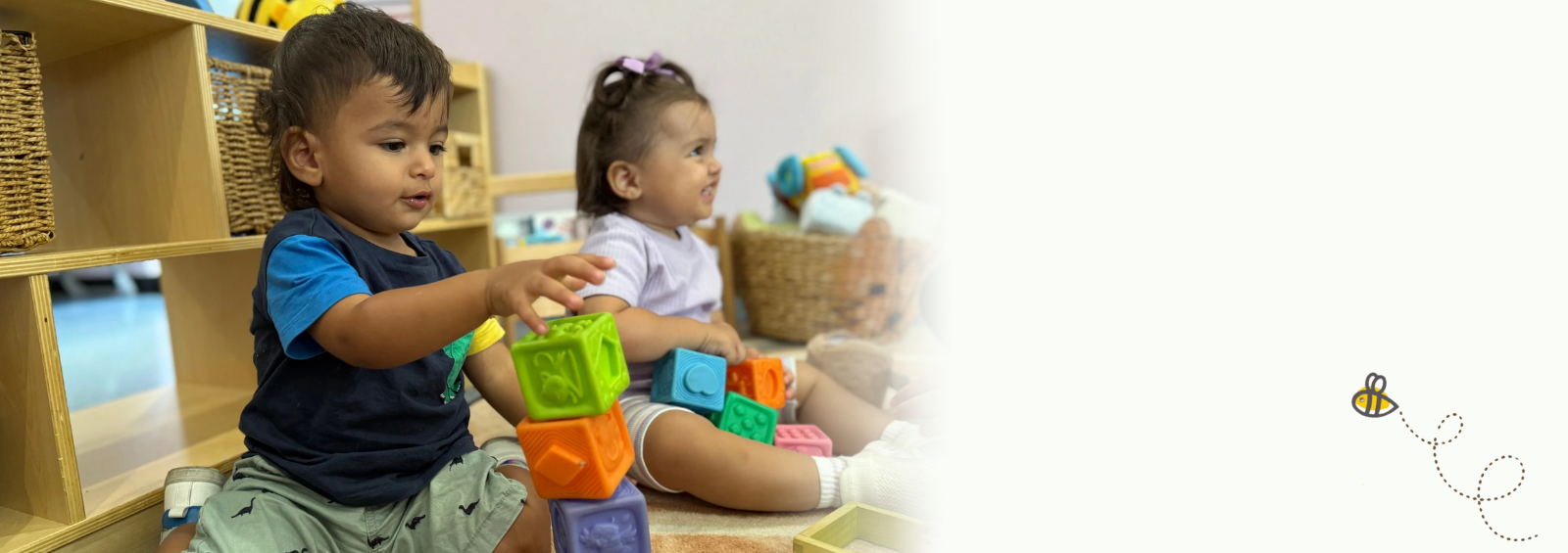 Child focused on arranging blocks in a creative play activity.